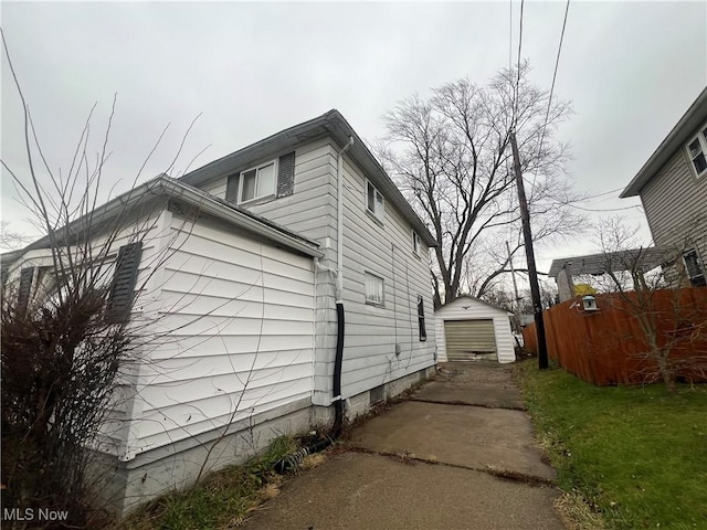 view of home's exterior with an outdoor structure and a garage