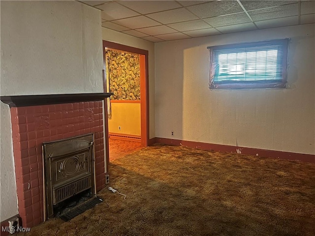 unfurnished living room featuring a drop ceiling and carpet floors