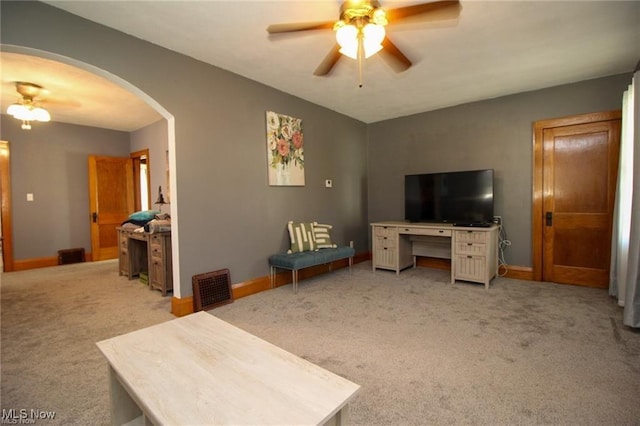 carpeted living room with ceiling fan