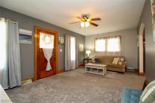 carpeted living room featuring ceiling fan