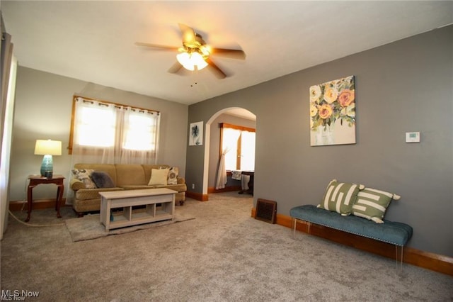 living room with ceiling fan and carpet