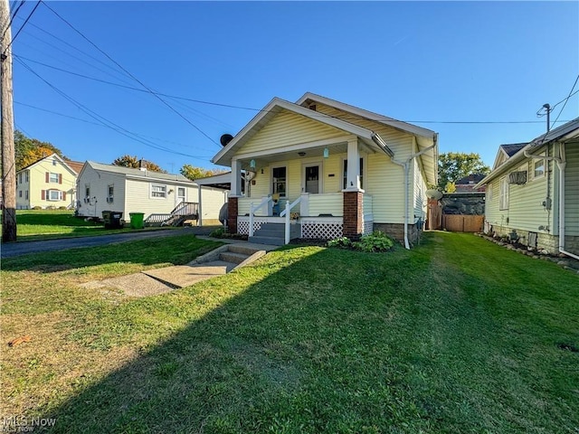 bungalow-style home with a porch and a front lawn