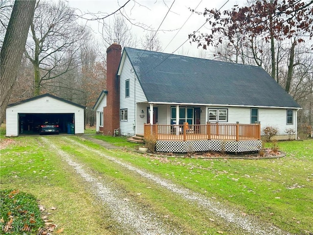 view of front of home with an outbuilding, a garage, a front lawn, and a deck