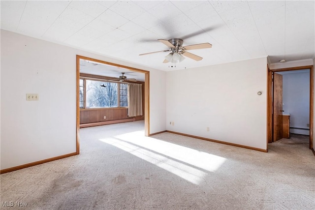 carpeted spare room featuring ceiling fan and a baseboard radiator