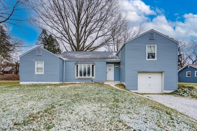 view of front of home featuring a garage and a front lawn