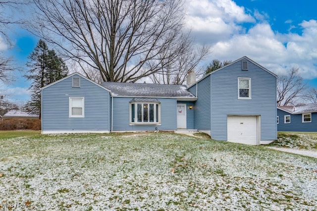 view of front of house with a front lawn and a garage