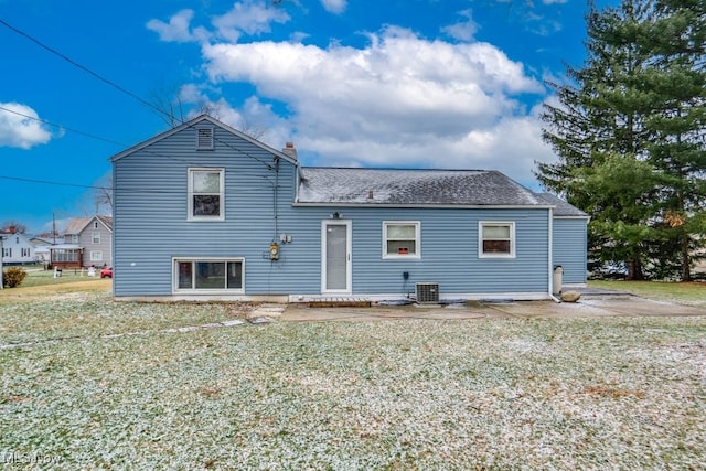 back of house featuring a yard and central air condition unit