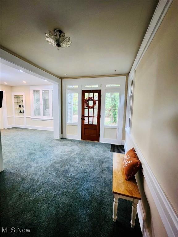 interior space with carpet floors and ornamental molding