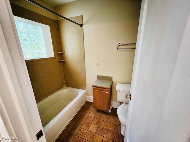 bathroom featuring tile patterned flooring, toilet, and tub / shower combination