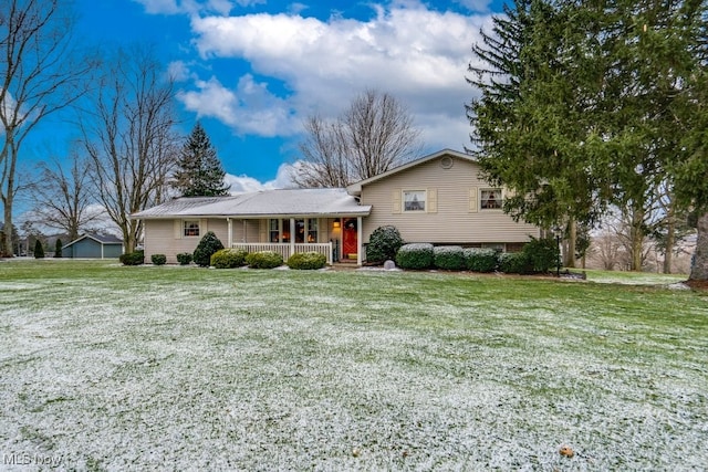 split level home with covered porch and a front lawn