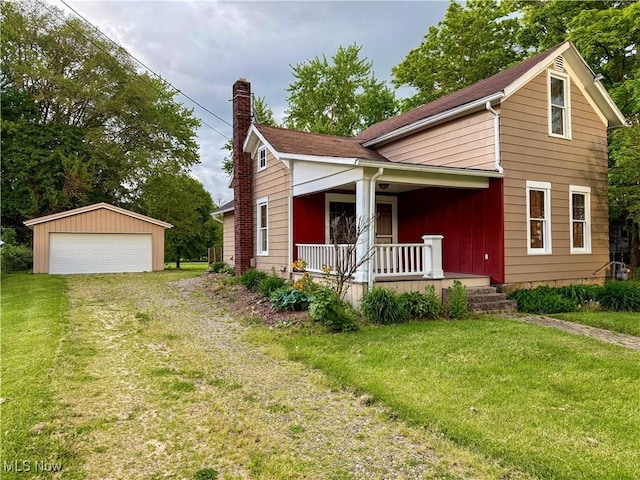 60 Liberty St, Seville, OH 44273 - view of front of home with a porch, a chimney, an outdoor structure, a front yard, and a detached garage