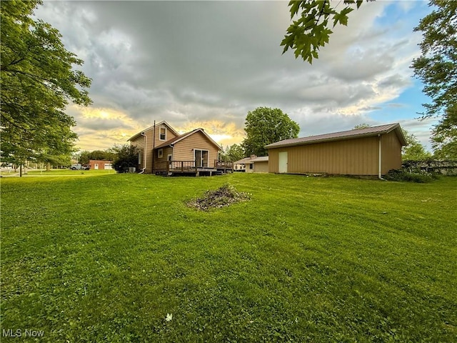 60 Liberty St, Seville, OH 44273 - view of green lawn with a deck and an outbuilding