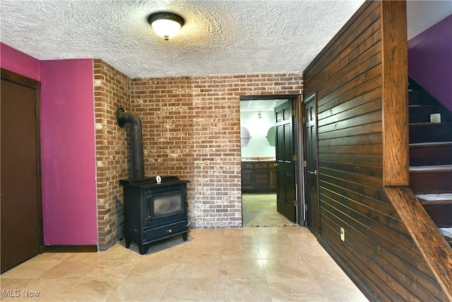 unfurnished living room featuring a wood stove