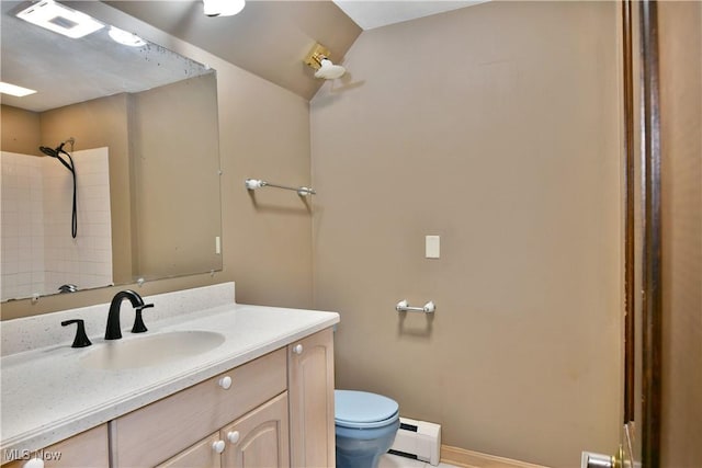 bathroom with vanity, toilet, and baseboard heating