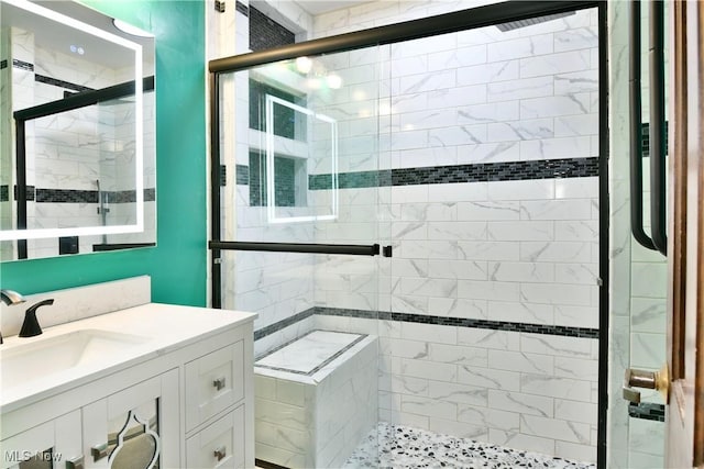 bathroom with vanity and a shower with door