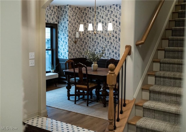 dining area featuring hardwood / wood-style floors and a notable chandelier