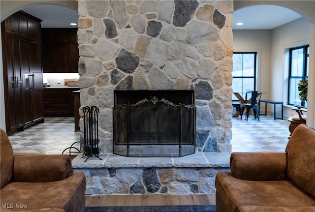 living room with a stone fireplace