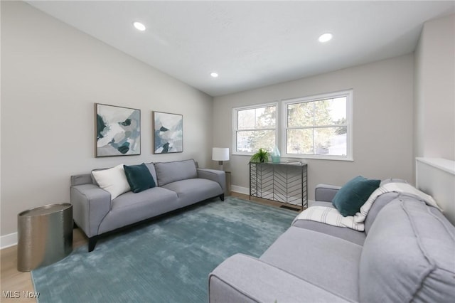 living room featuring dark hardwood / wood-style flooring and lofted ceiling