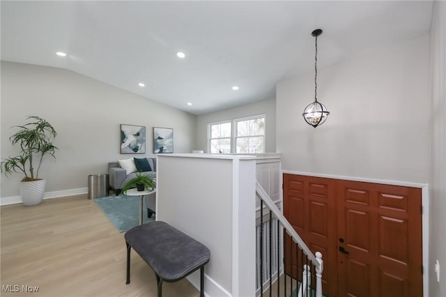 entrance foyer featuring light hardwood / wood-style floors and lofted ceiling