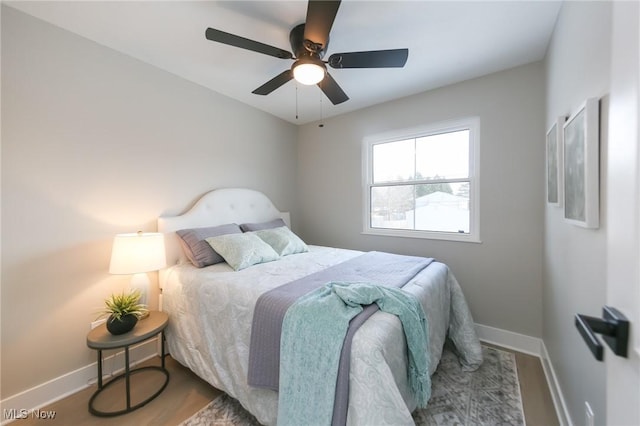 bedroom with ceiling fan and wood-type flooring