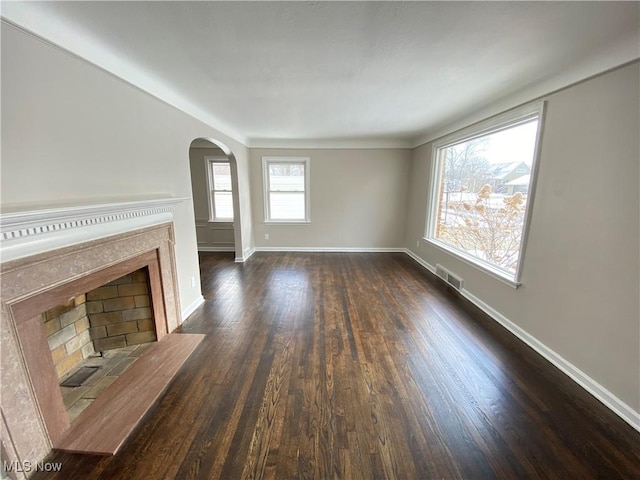 unfurnished living room with dark hardwood / wood-style flooring