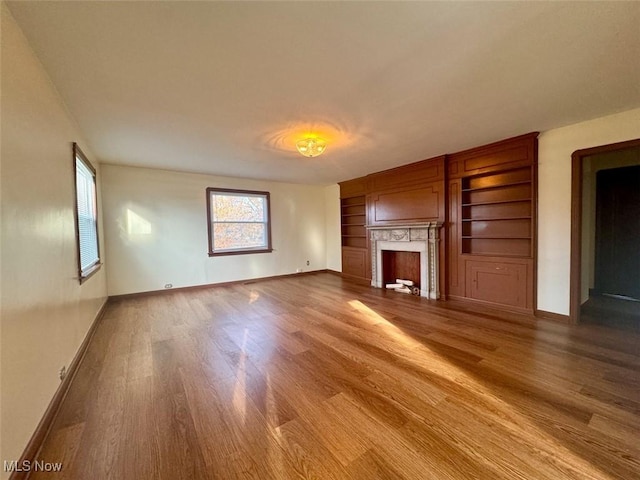 unfurnished living room featuring hardwood / wood-style flooring