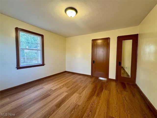 empty room with hardwood / wood-style floors