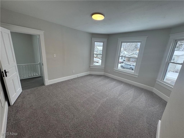 unfurnished room with dark carpet