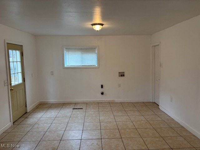 unfurnished room with light tile patterned flooring