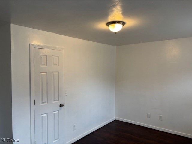 empty room featuring dark wood-type flooring