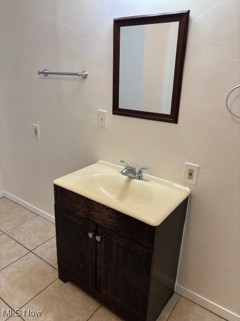 bathroom with tile patterned flooring and vanity