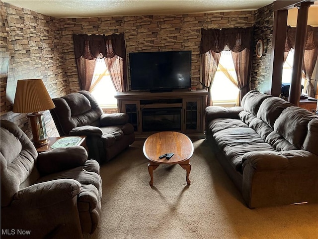 carpeted living room featuring a large fireplace