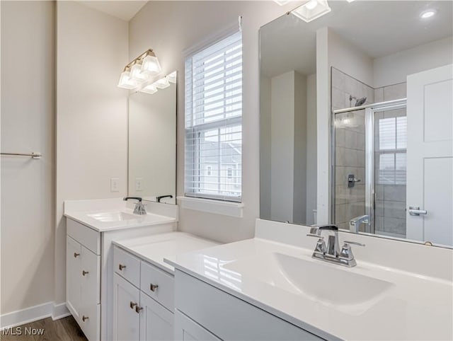 bathroom with vanity, hardwood / wood-style flooring, and walk in shower