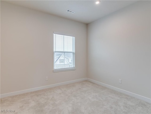 empty room featuring light colored carpet