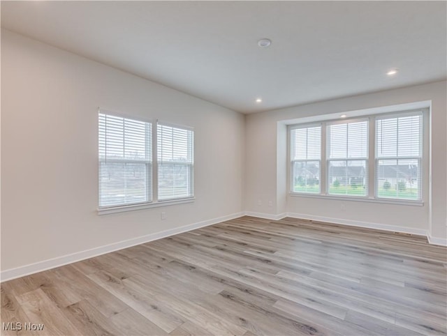 empty room with light hardwood / wood-style flooring