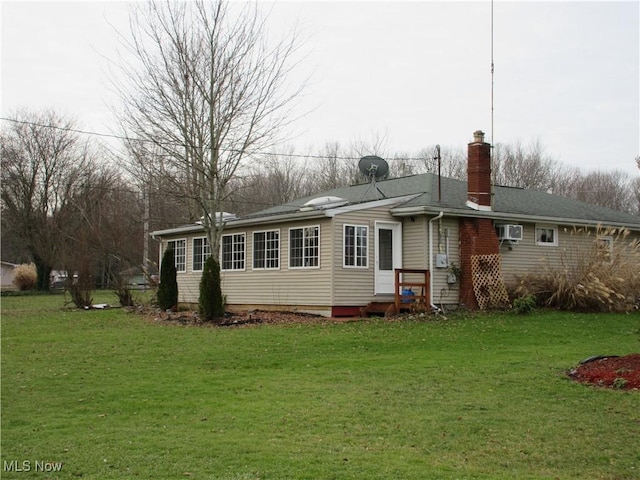 back of house featuring a lawn