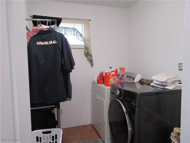 washroom with tile patterned floors and washer and dryer