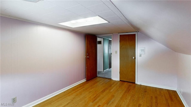 bonus room featuring lofted ceiling and light hardwood / wood-style flooring