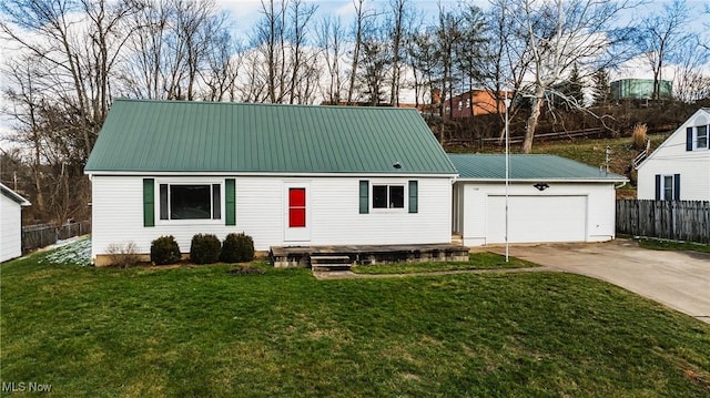 view of front of home with a garage and a front lawn