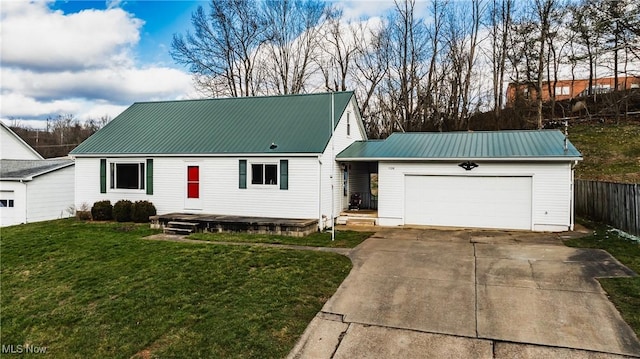 view of front of property with a garage and a front lawn