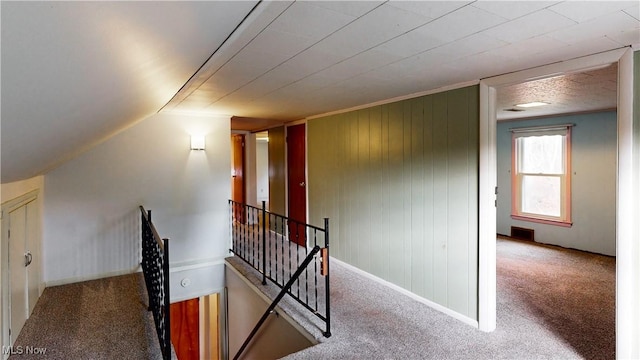 interior space with carpet floors and vaulted ceiling