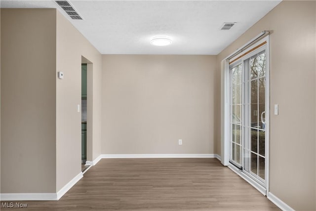 empty room with light hardwood / wood-style floors