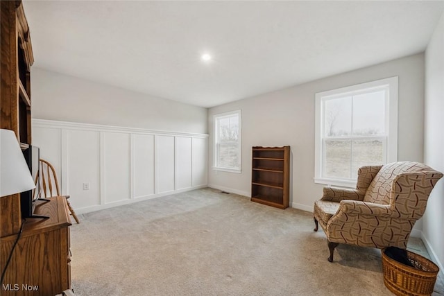 living area featuring light colored carpet