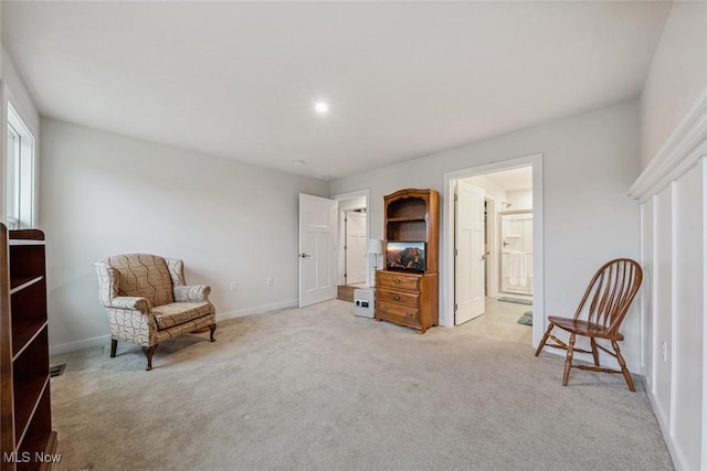 living area with light carpet