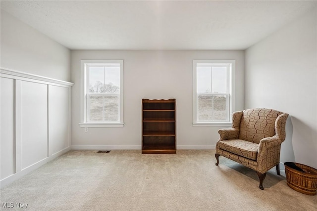 living area featuring light colored carpet