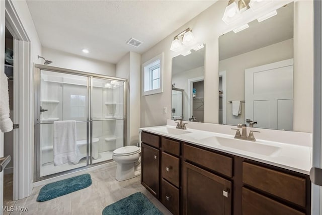 bathroom featuring vanity, toilet, and walk in shower