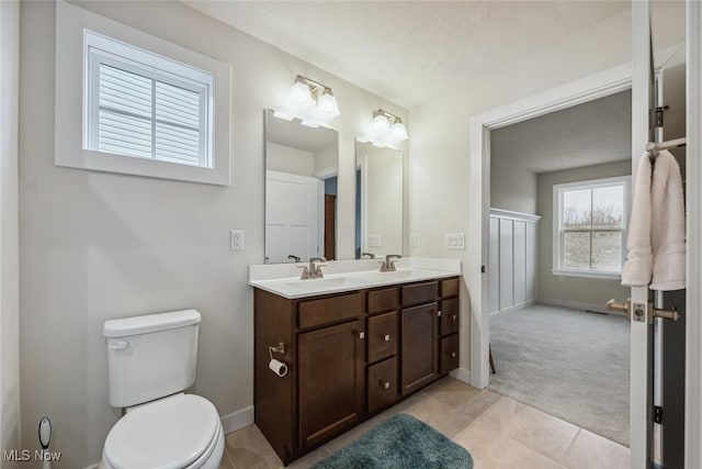 bathroom featuring vanity, toilet, and a textured ceiling