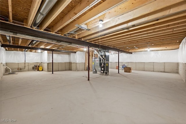 basement featuring heating unit and water heater