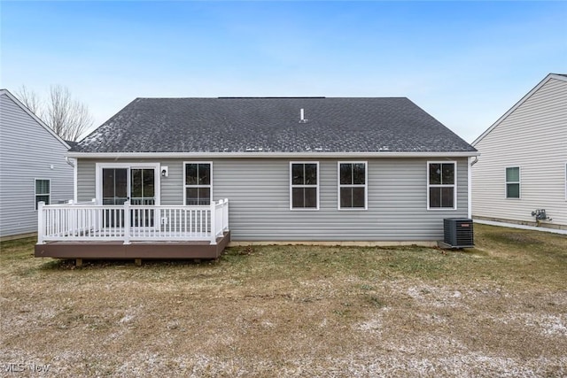 back of property with a lawn, cooling unit, and a deck