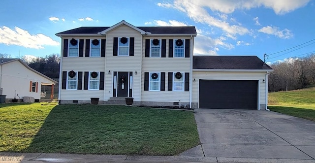 colonial inspired home featuring a garage and a front yard